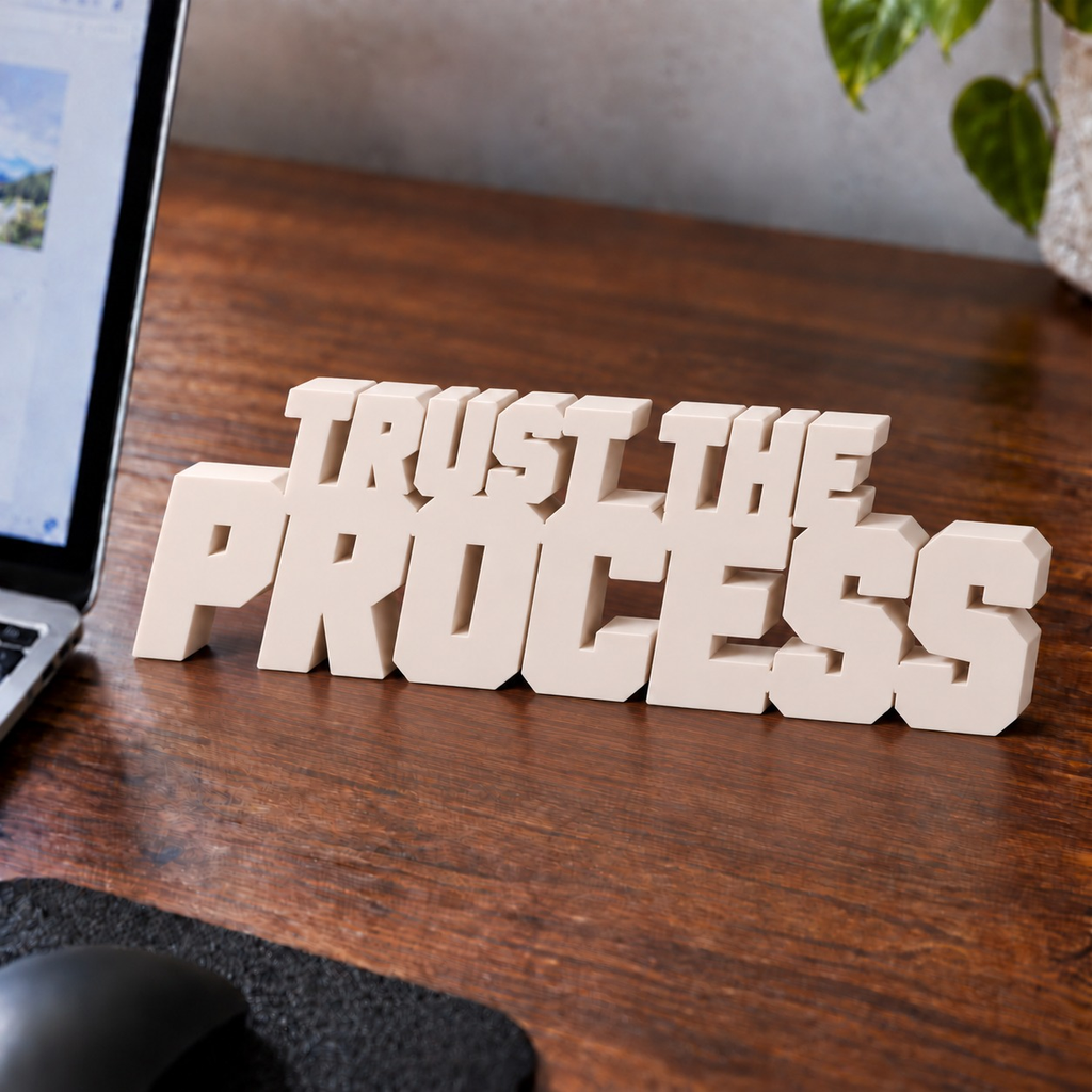 Trust the Process desk letters in Ivory on an office desk
