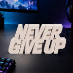 Never Give Up desk letters in Ivory on a gaming desk