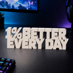 1% Better Every Day desk letters in Ivory on a gaming desk