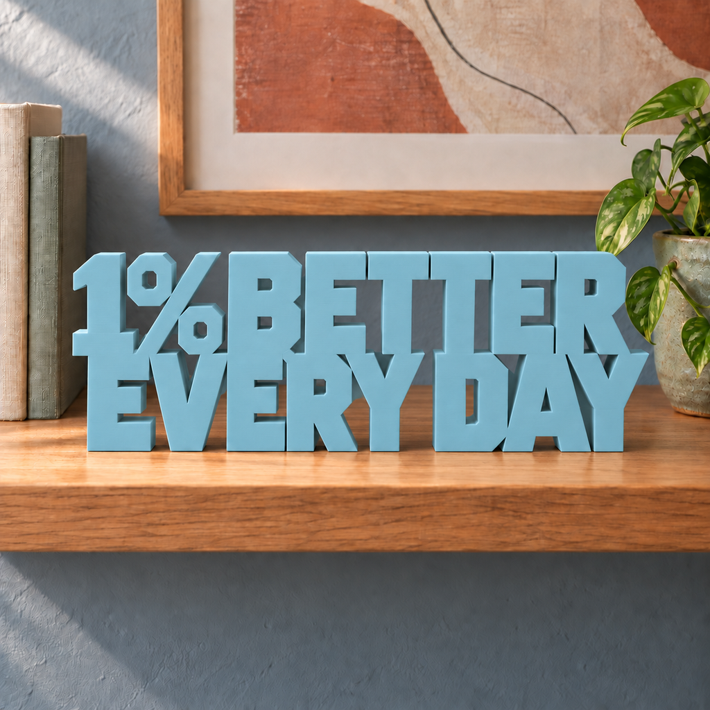 1% Better Every Day desk letters – Teal Blue on the ledge
