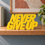 Never Give Up desk letters – Yellow on the ledge