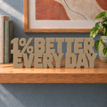 1% Better Every Day desk letters – Sandstorm on the ledge