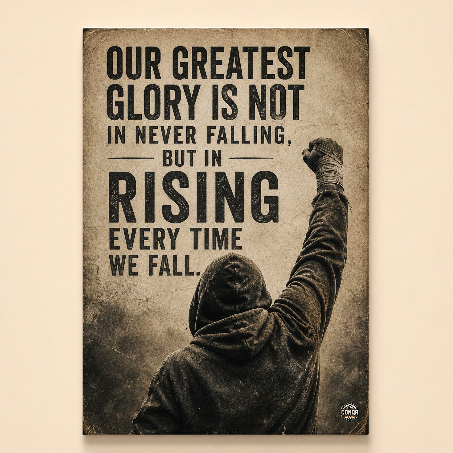 Hooded figure from behind raising a taped fist in sepia – rising every time we fall quote