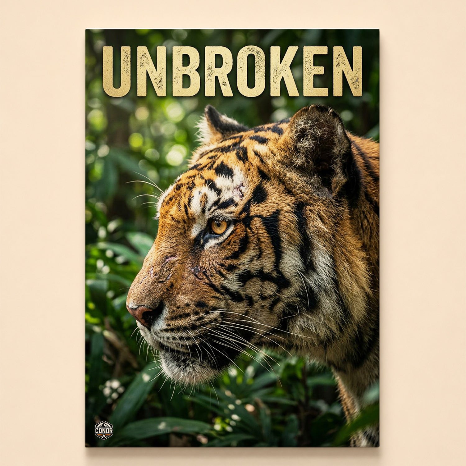 Tiger head in profile framed by jungle foliage under the word Unbroken in gold lettering