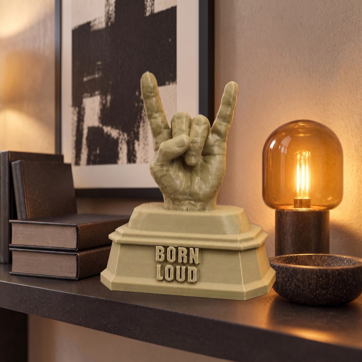Born Loud XL on a dark shelf, shown to scale beside books and an amber lamp