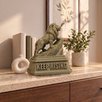 The Lion XXL on a marble-topped shelf, shown to scale beside books, a vase and a plant