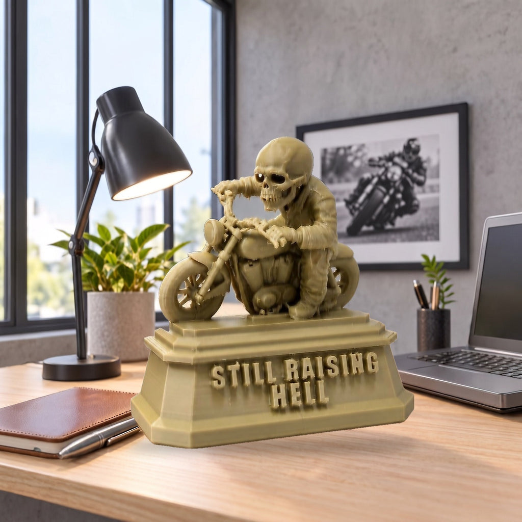 Still Raising Hell XL on a bright desk, shown to scale beside a laptop and lamp